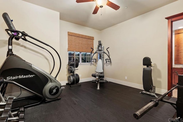 exercise area featuring ceiling fan and baseboards