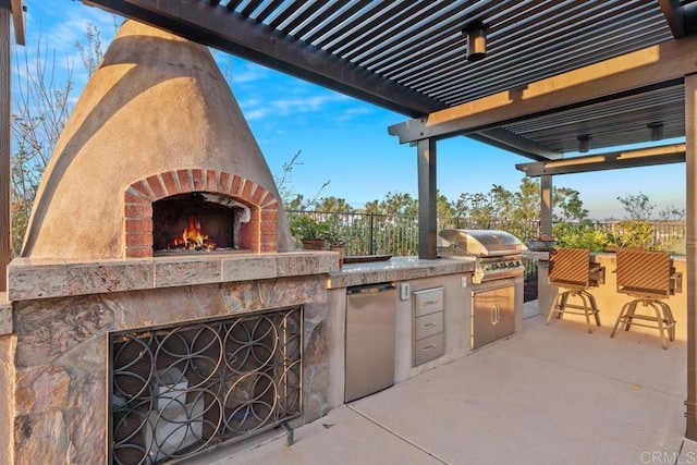 view of patio / terrace with grilling area, fence, a pergola, an outdoor brick fireplace, and exterior kitchen