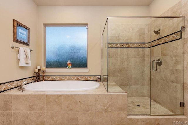 bathroom with a stall shower and a bath