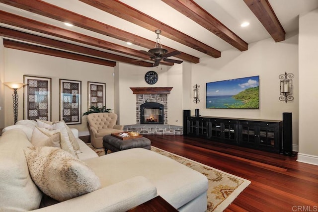 living room with baseboards, wood finished floors, a stone fireplace, beam ceiling, and recessed lighting