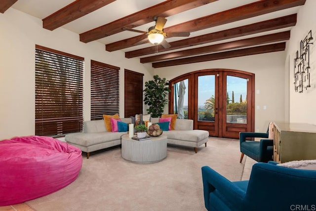 carpeted living room with a ceiling fan, french doors, and beam ceiling