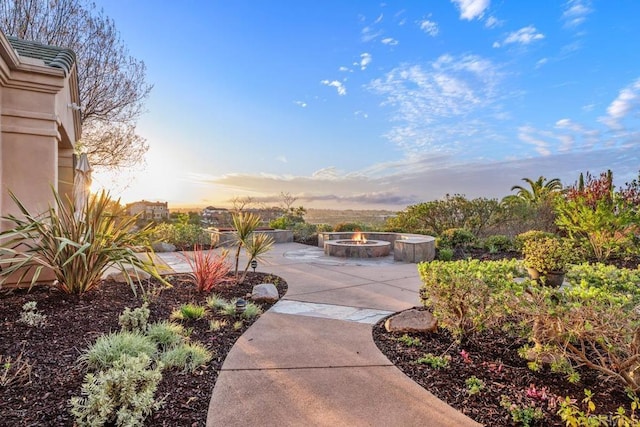 view of community with a patio area and a fire pit