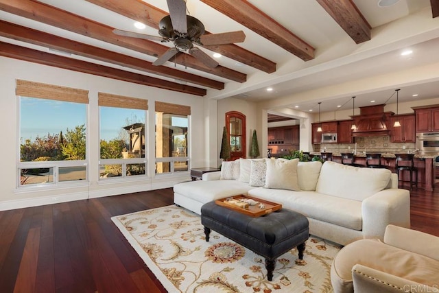 living area featuring a ceiling fan, recessed lighting, dark wood-style flooring, and beam ceiling