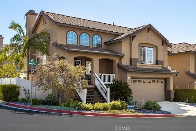 mediterranean / spanish house featuring a porch, stucco siding, a tiled roof, and an attached garage