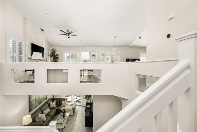 interior space with visible vents, a high ceiling, and tile patterned flooring