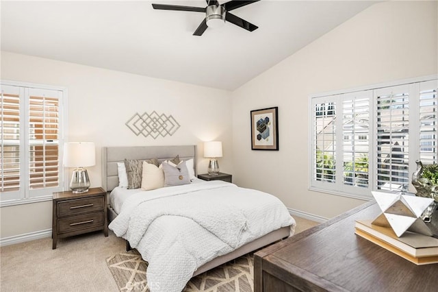 bedroom featuring baseboards, lofted ceiling, light colored carpet, and a ceiling fan