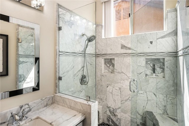 full bathroom featuring a stall shower and vanity