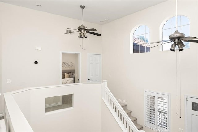 interior space with an upstairs landing and a towering ceiling