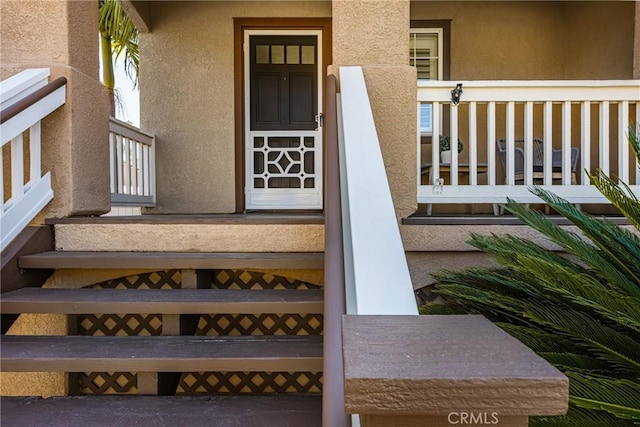 property entrance featuring stucco siding