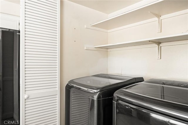 washroom featuring laundry area and separate washer and dryer