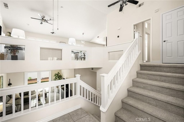 staircase featuring tile patterned floors, visible vents, and ceiling fan