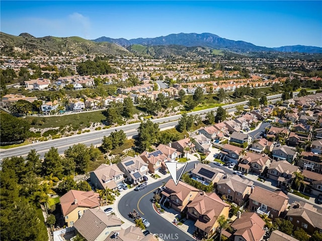 drone / aerial view featuring a residential view and a mountain view