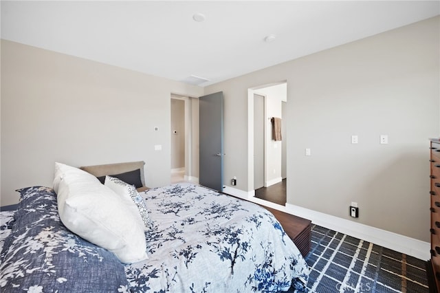 bedroom featuring baseboards and wood finished floors