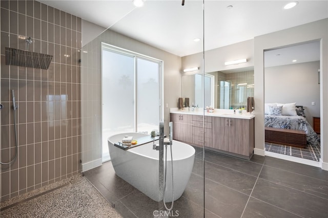 ensuite bathroom featuring a freestanding tub, connected bathroom, a walk in shower, vanity, and recessed lighting