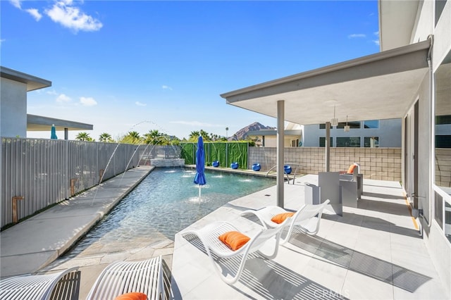 view of swimming pool with a fenced backyard, a fenced in pool, and a patio area
