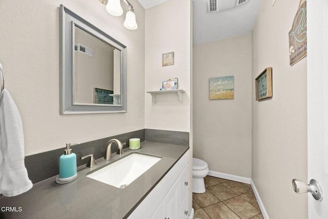 bathroom featuring visible vents, vanity, toilet, and tile patterned floors