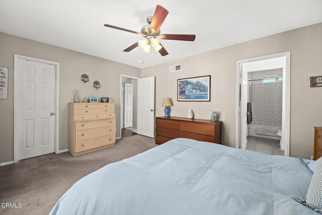 carpeted bedroom featuring baseboards, visible vents, a ceiling fan, and ensuite bathroom