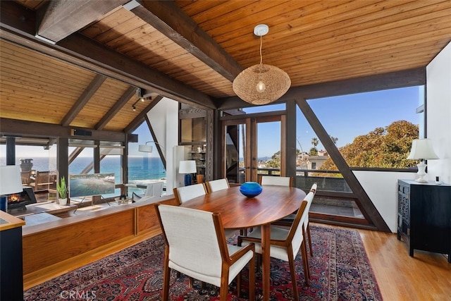 dining area featuring wooden ceiling, vaulted ceiling with beams, french doors, and wood finished floors