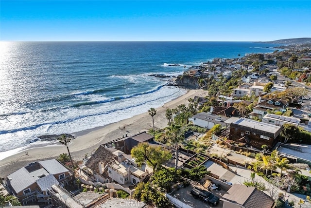 birds eye view of property featuring a water view, a residential view, and a beach view