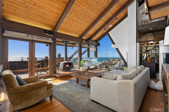 living area featuring wooden ceiling, plenty of natural light, beamed ceiling, and wood finished floors