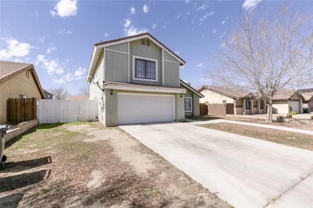 traditional home featuring driveway, a garage, fence, and stucco siding