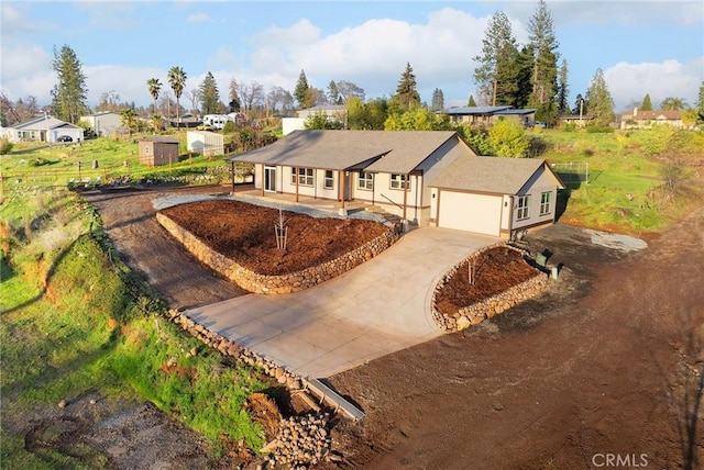 single story home with driveway and an attached garage