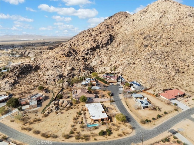 birds eye view of property with a mountain view and a desert view