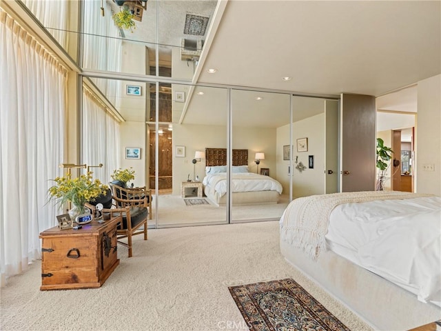 carpeted bedroom featuring a closet and recessed lighting