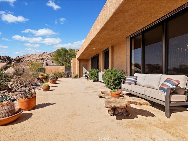 view of patio with a mountain view and outdoor lounge area