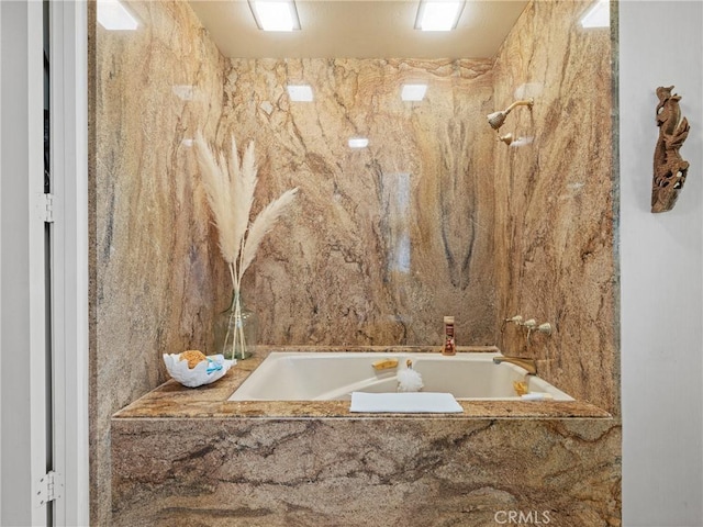 full bathroom with a tub with marble appearance