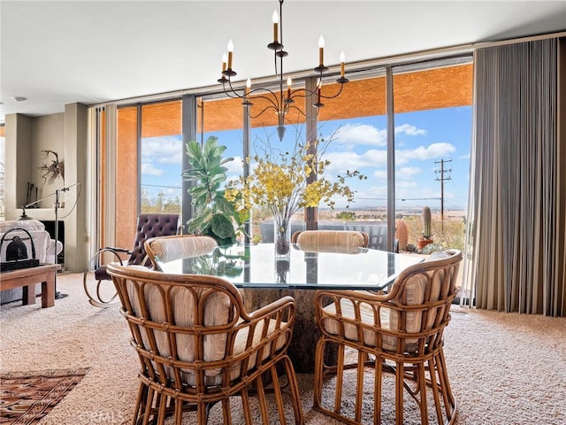 dining space with a wall of windows, carpet, and an inviting chandelier