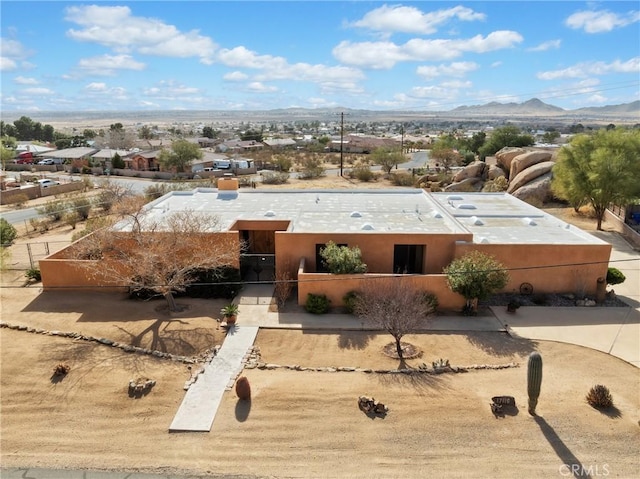 pueblo revival-style home featuring a mountain view and stucco siding