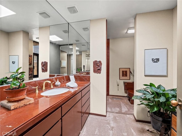 bathroom with visible vents, vanity, and baseboards