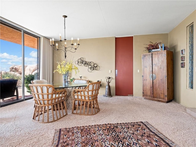 dining space with carpet floors, expansive windows, and a chandelier