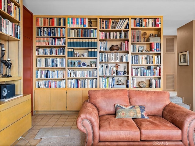 living area featuring light tile patterned floors and visible vents