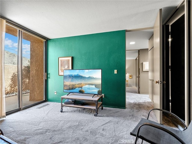 sitting room featuring carpet floors and a wall of windows