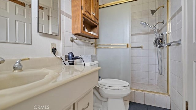 full bath with vanity, a shower stall, and toilet