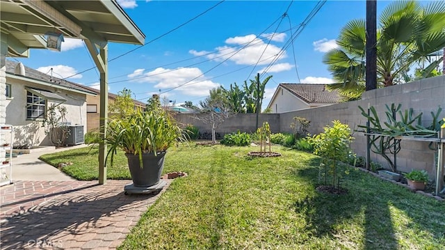 view of yard featuring cooling unit, a patio area, and a fenced backyard