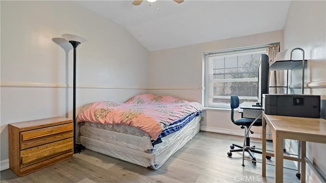 bedroom featuring ceiling fan, vaulted ceiling, baseboards, and wood finished floors