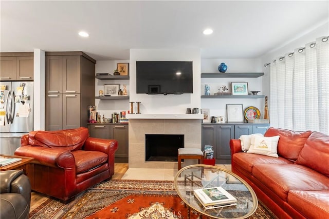 living room featuring recessed lighting and a tiled fireplace