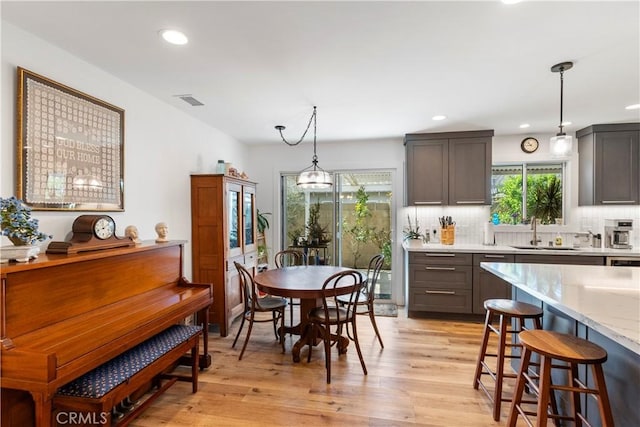 dining area with visible vents, light wood-style flooring, and recessed lighting