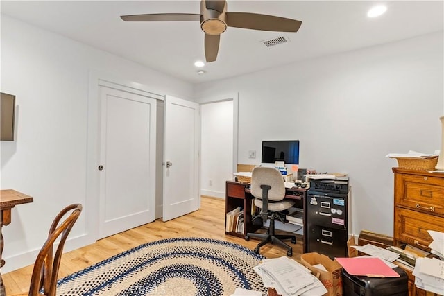 office space featuring ceiling fan, light wood finished floors, visible vents, and recessed lighting