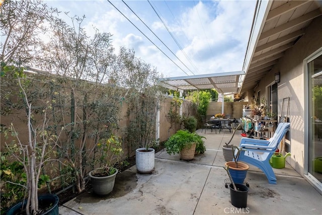 view of patio / terrace with outdoor dining area, a fenced backyard, and a pergola