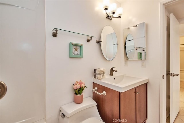 bathroom featuring toilet and vanity