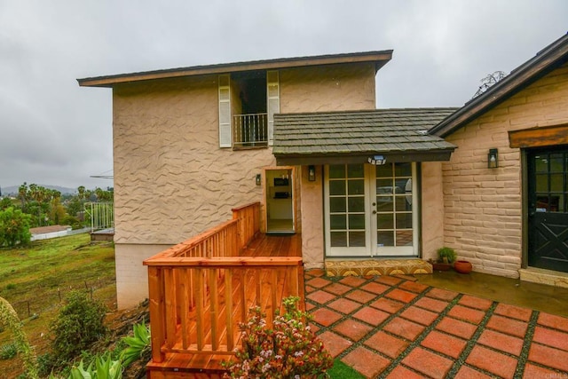 back of property with french doors, a patio area, and stucco siding