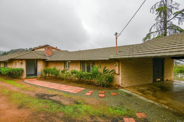 ranch-style house featuring brick siding