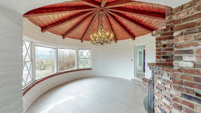 unfurnished sunroom with lofted ceiling with beams, wooden ceiling, and a notable chandelier