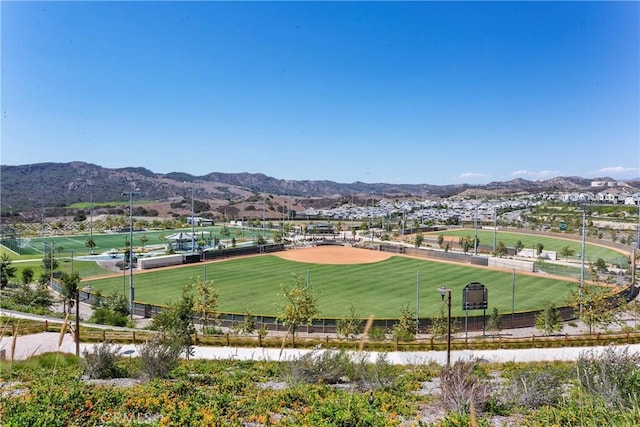 surrounding community featuring a mountain view and fence