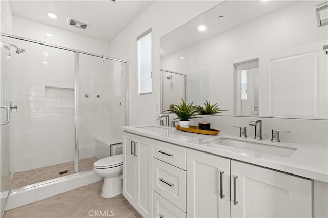 full bathroom with a sink, toilet, and a shower stall