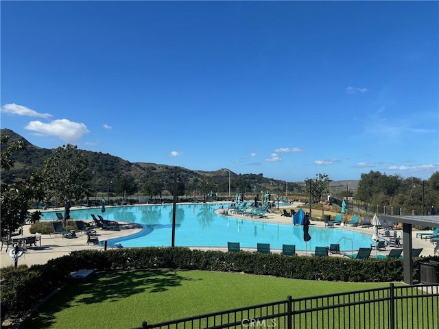 view of water feature featuring fence and a mountain view